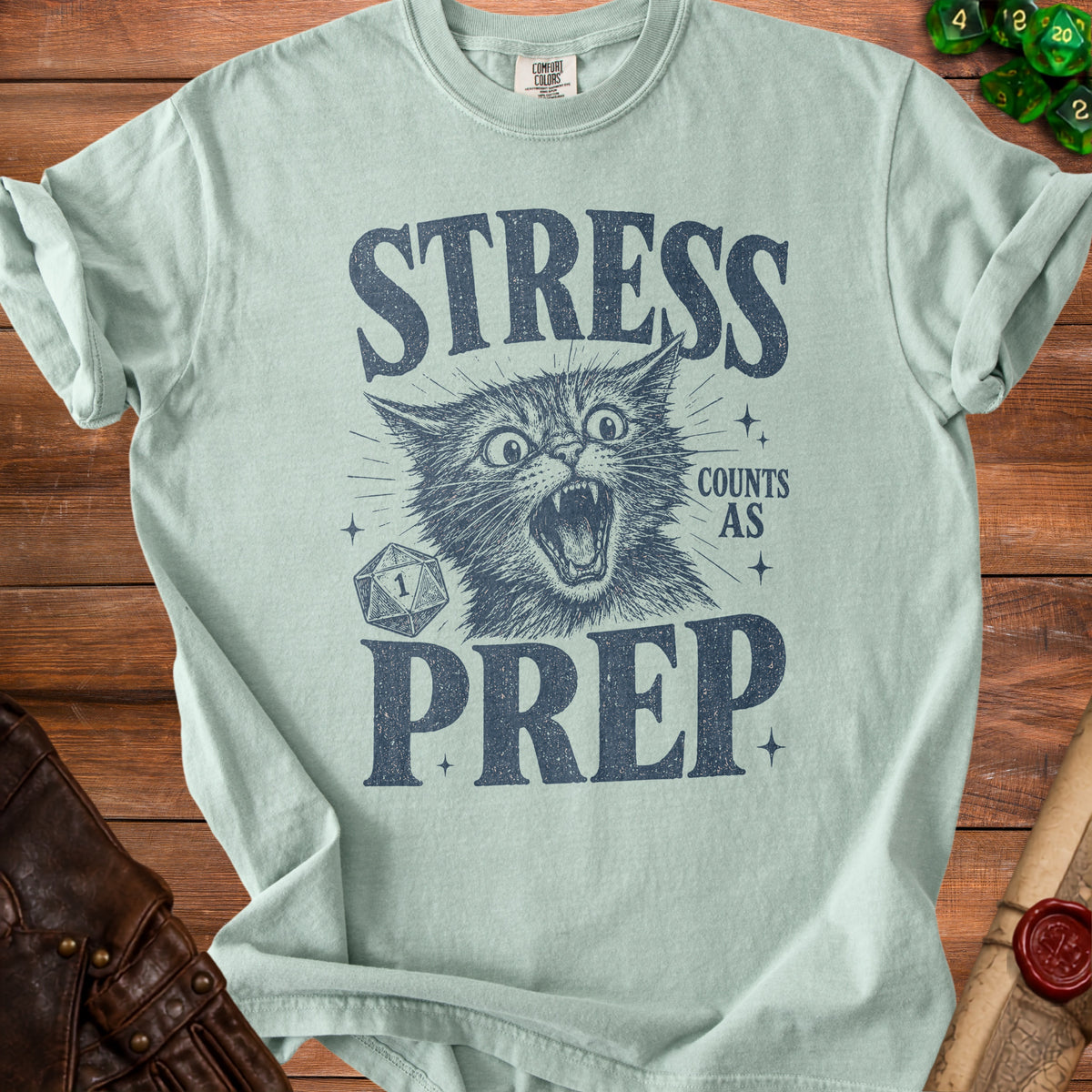 Light blue t-shirt with distressed graphic of a screaming cat, d20 dice, and text.