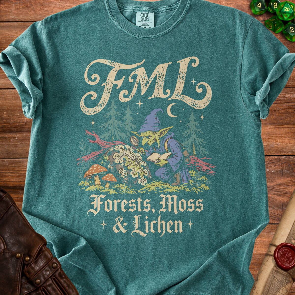 Teal t-shirt with "FML" and goblin examining plants, "Forests, Moss & Lichen".