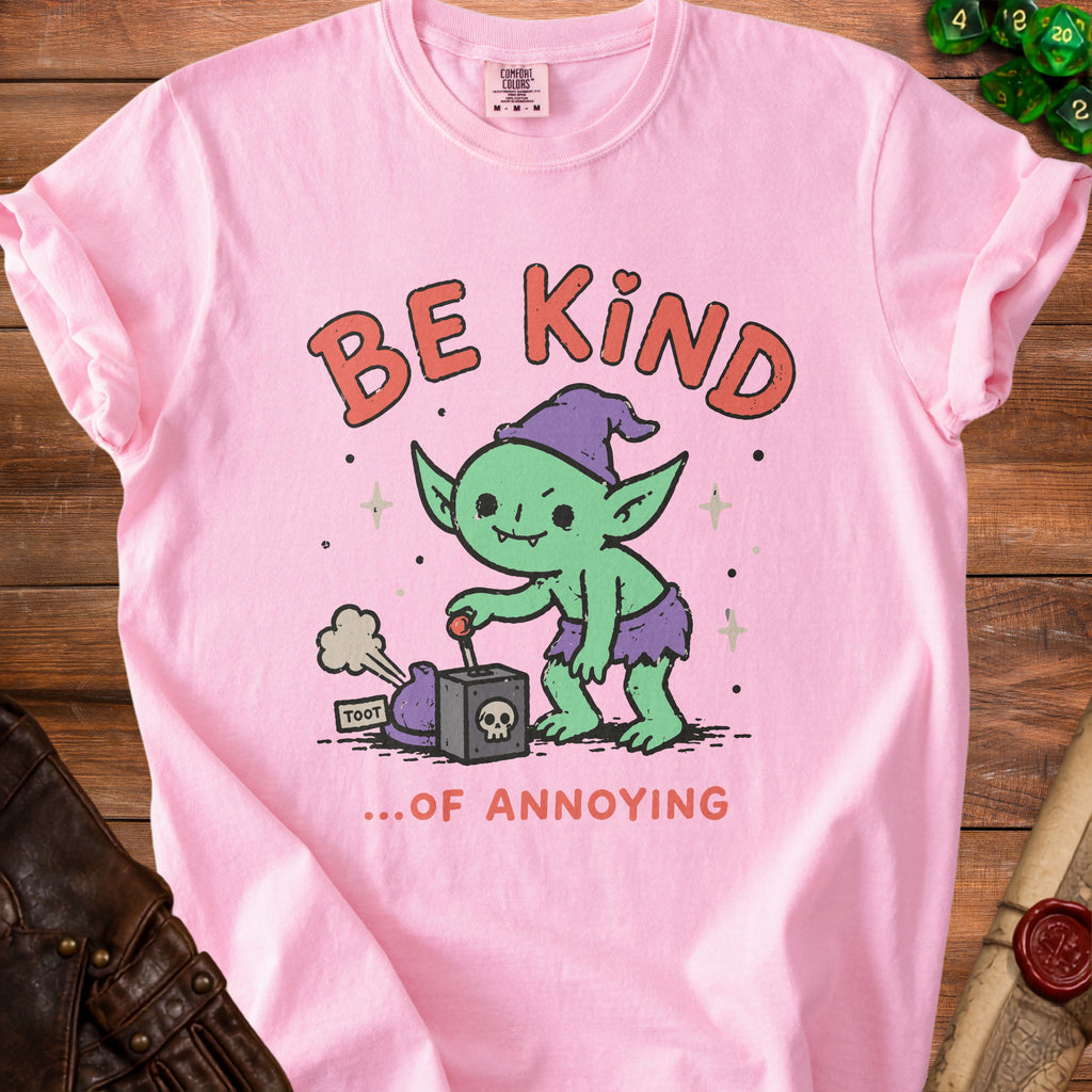 Pink t-shirt with a cartoon goblin activating a device that says "TOOT" and text "BE KIND ...OF ANNOYING".