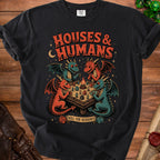 Four cartoon dragons play a tabletop game with miniature houses and people.