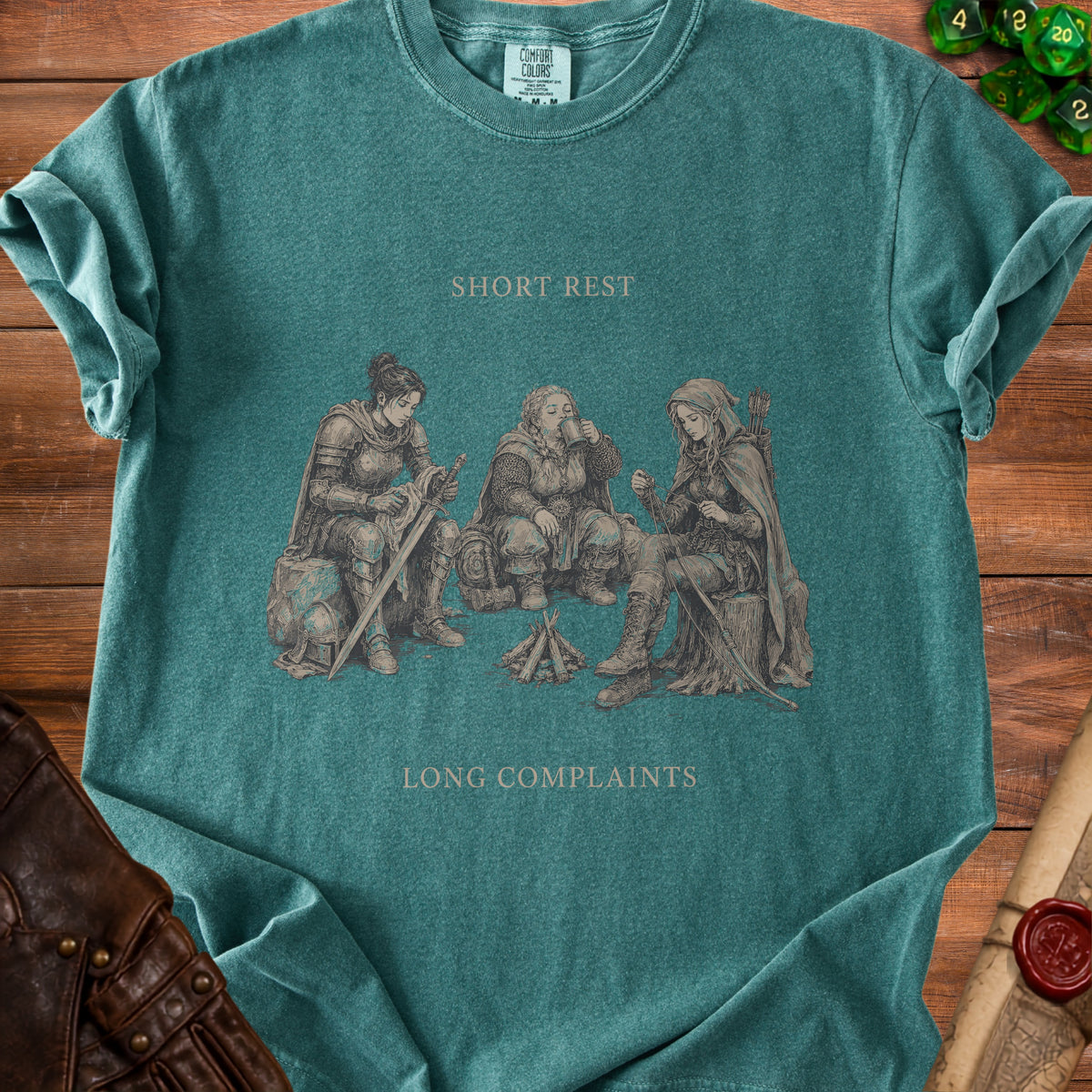 T-shirt graphic with text "SHORT REST LONG COMPLAINTS" and fantasy characters by campfire.
