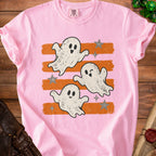 Pink t-shirt with three cartoon ghosts and orange stripes.
