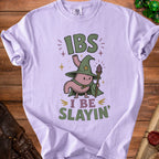 Lilac t-shirt with cartoon stomach wizard graphic saying "IBS I BE SLAYIN'".