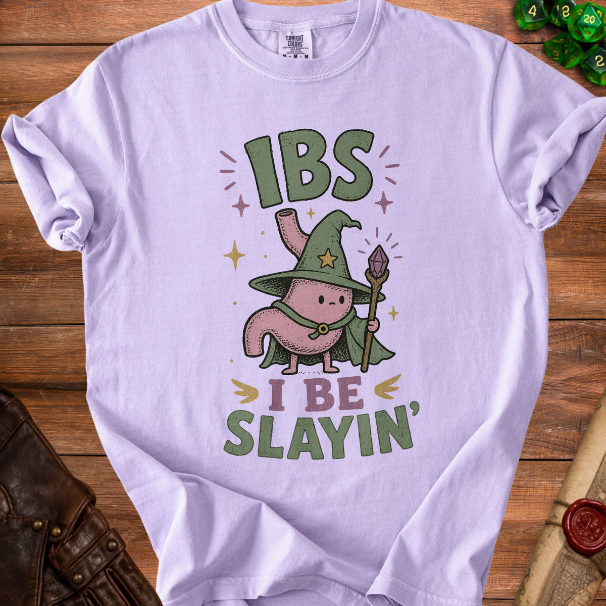 Lilac t-shirt with cartoon stomach wizard graphic saying "IBS I BE SLAYIN'".