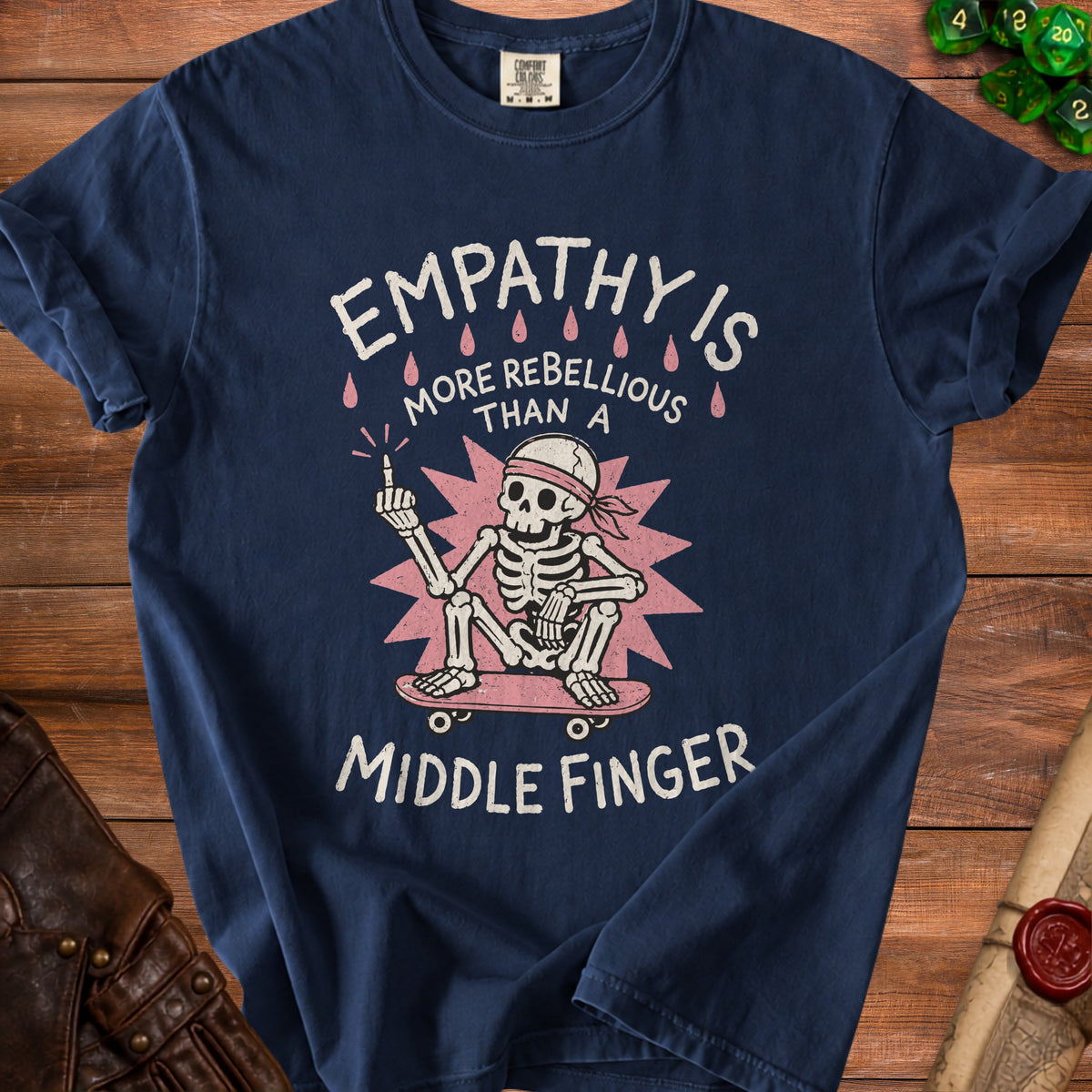 Skeleton on skateboard with "Empathy is more rebellious than a middle finger" text.