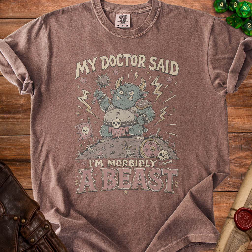 Brown t-shirt with monster illustration and text "MY DOCTOR SAID I'M MORBIDLY A BEAST".