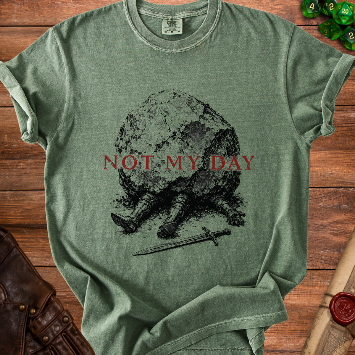 Green t-shirt with illustration of a knight crushed by a boulder and the text "NOT MY DAY".