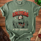 Green t-shirt with opossum graphic and text "How Am I Supposed To Lollygag In These Conditions?".