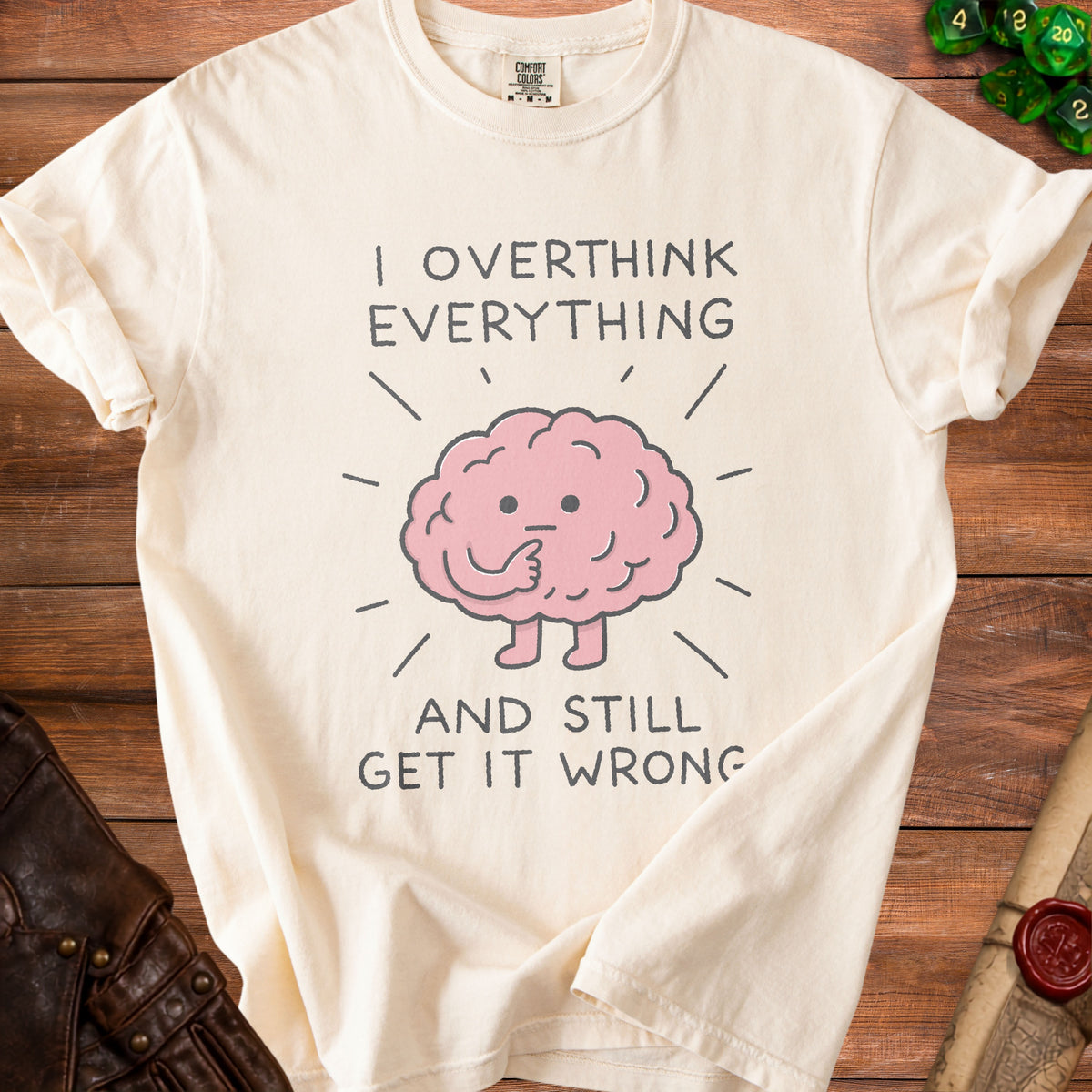 Cream t-shirt with text "I OVERTHINK EVERYTHING AND STILL GET IT WRONG" and a brain graphic.