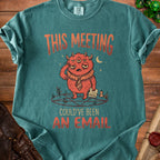 T-shirt with "This meeting could've been an email" text and a tired, multi-eyed monster.