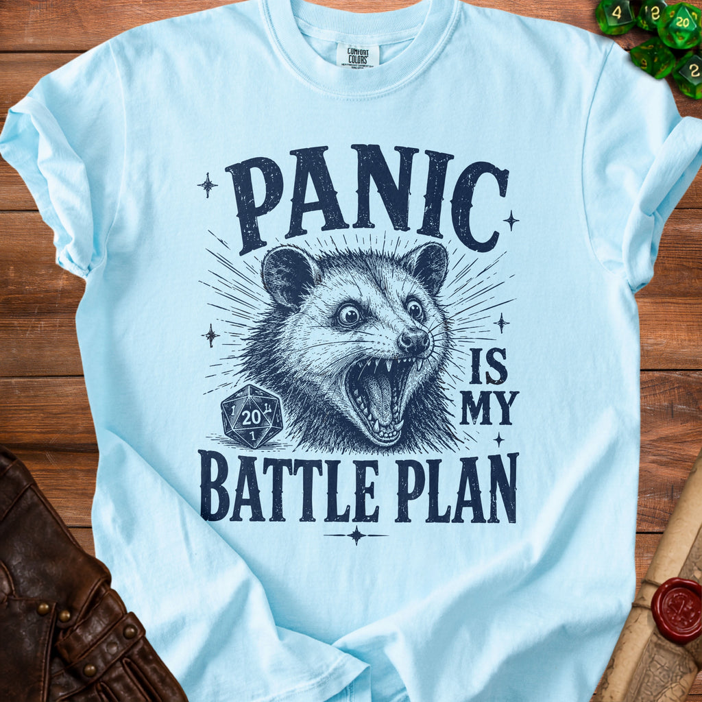 Light blue t-shirt with possum graphic and text "Panic is my battle plan".