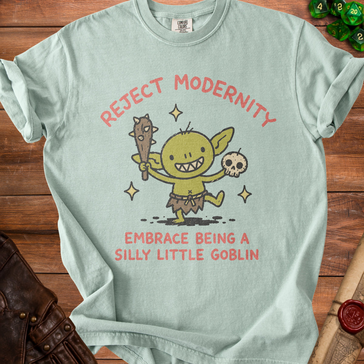 Light blue t-shirt with a cartoon goblin and text "Reject Modernity Embrace Being a Silly Little Goblin".