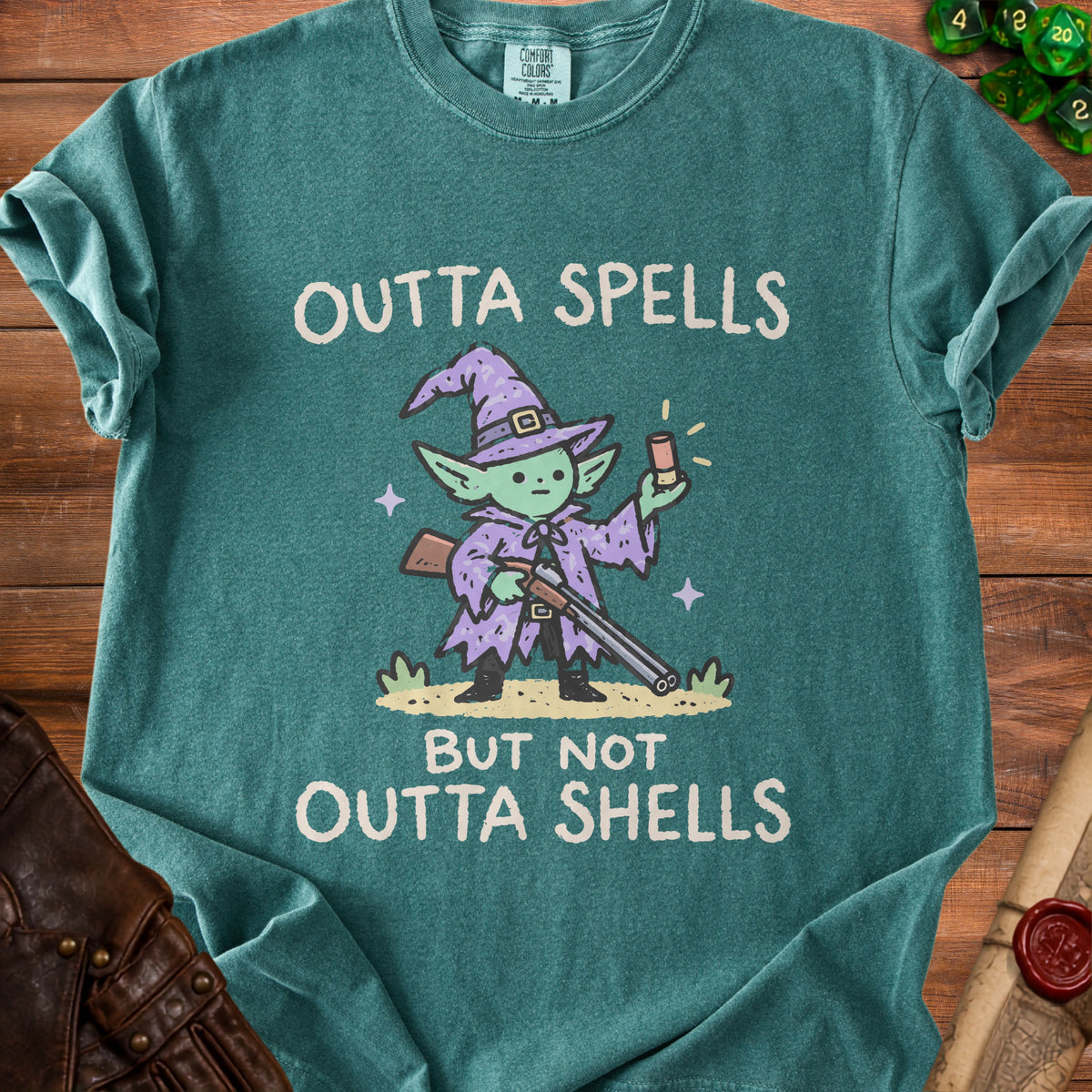 Green t-shirt with cartoon wizard holding a shotgun and the text "Outta Spells but not Outta Shells".