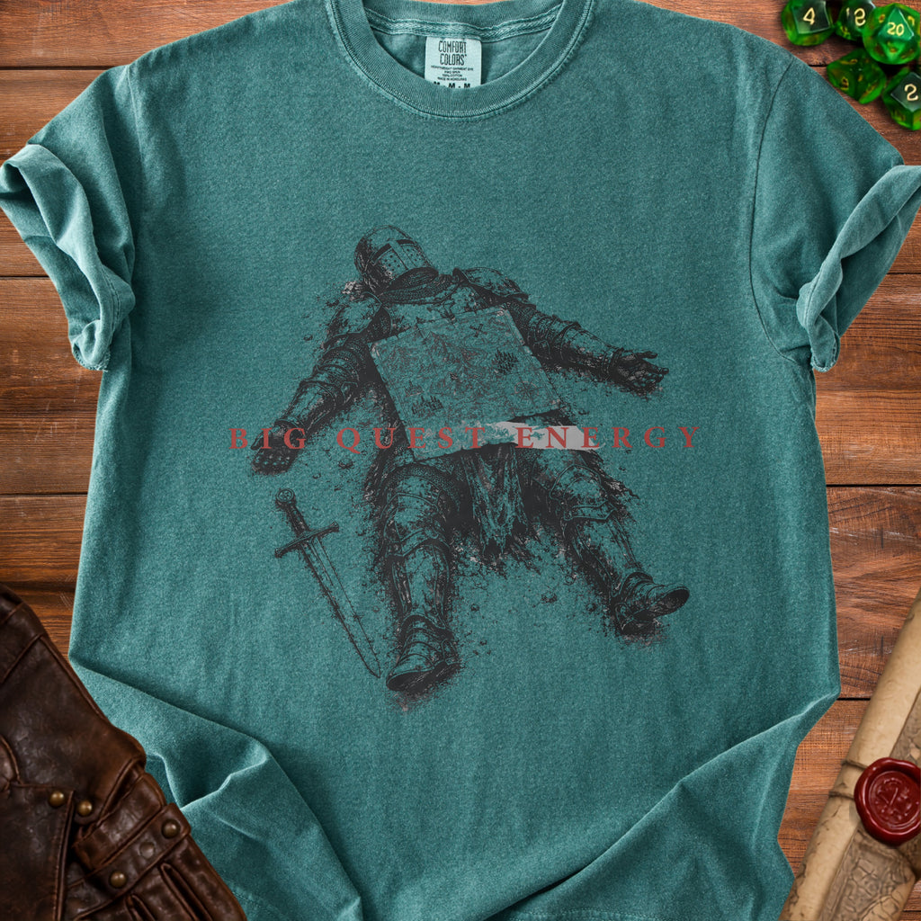 Teal t-shirt with a graphic of a fallen knight and the text "BIG QUEST ENERGY".