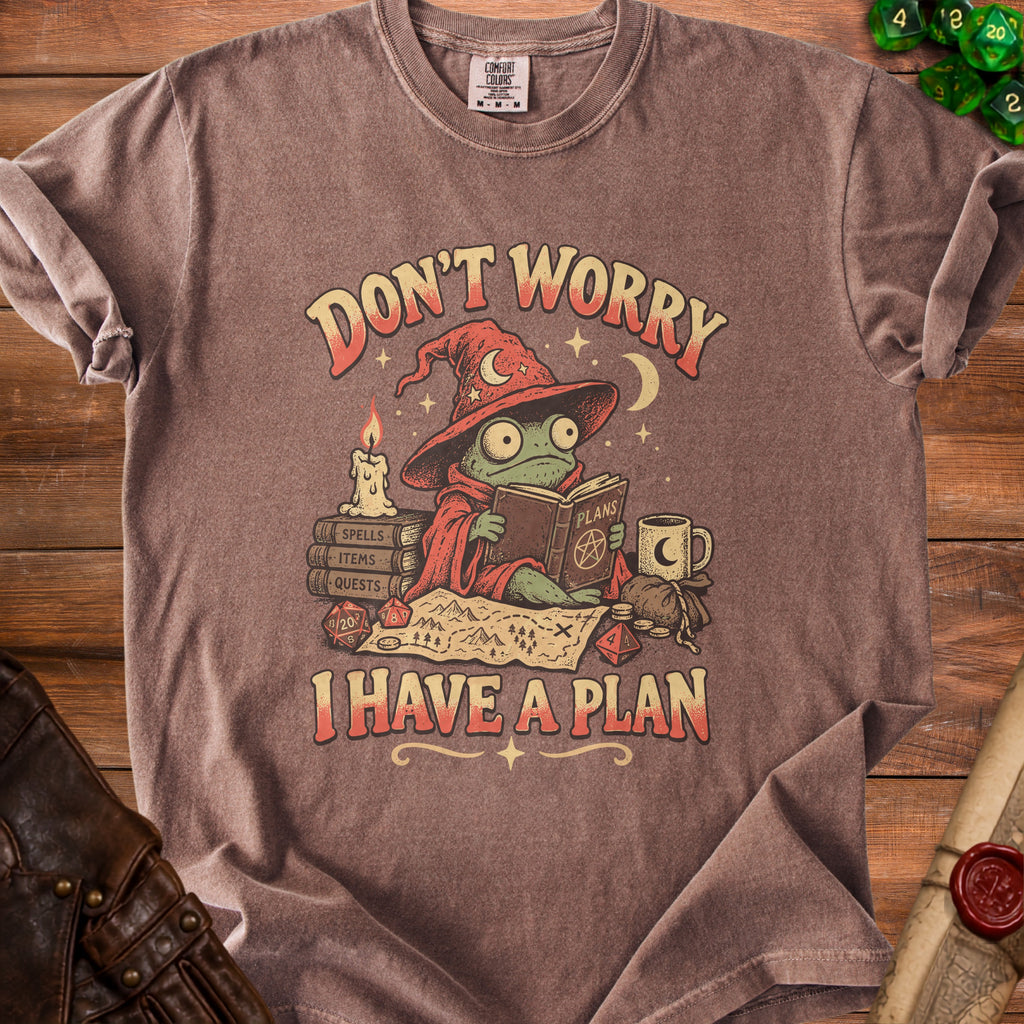 T-shirt graphic of a frog wizard reading "I HAVE A PLAN" surrounded by fantasy items.
