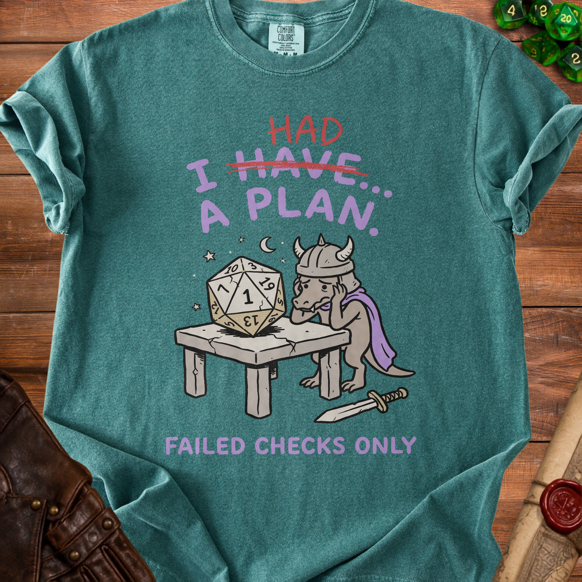 Green t-shirt with a dragon and dice graphic reading "I HAD A PLAN. Failed Checks Only."