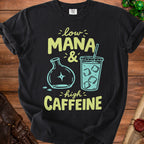 Black t-shirt with text "low MANA & high CAFFEINE" and graphics.