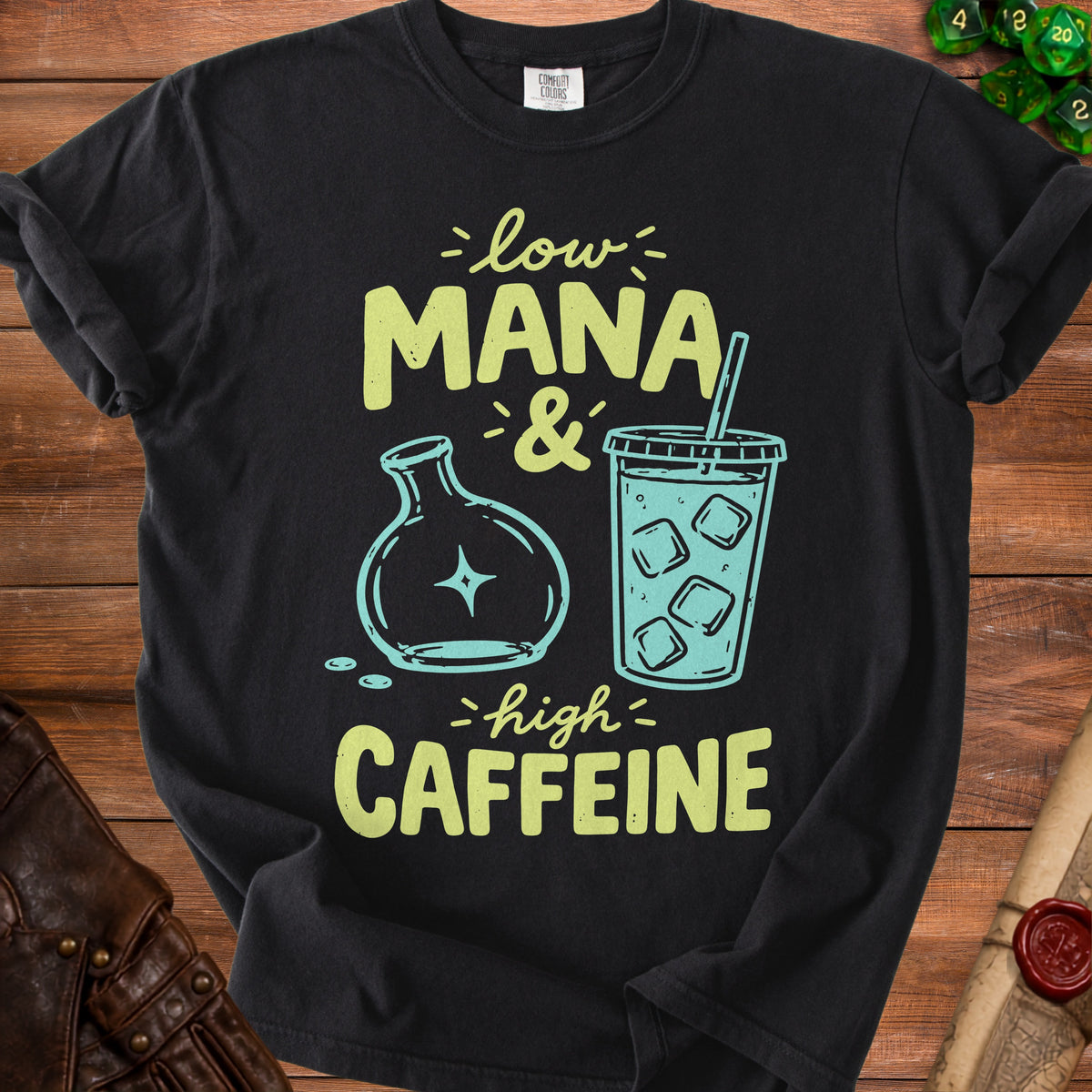 Black t-shirt with text "low MANA & high CAFFEINE" and graphics.