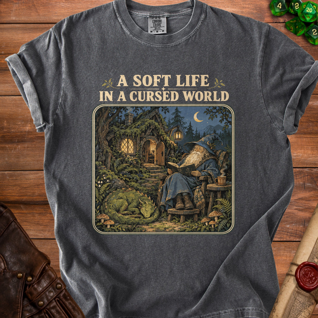 Dark t-shirt with "A Soft Life In A Cursed World" text above wizard and dragon illustration.