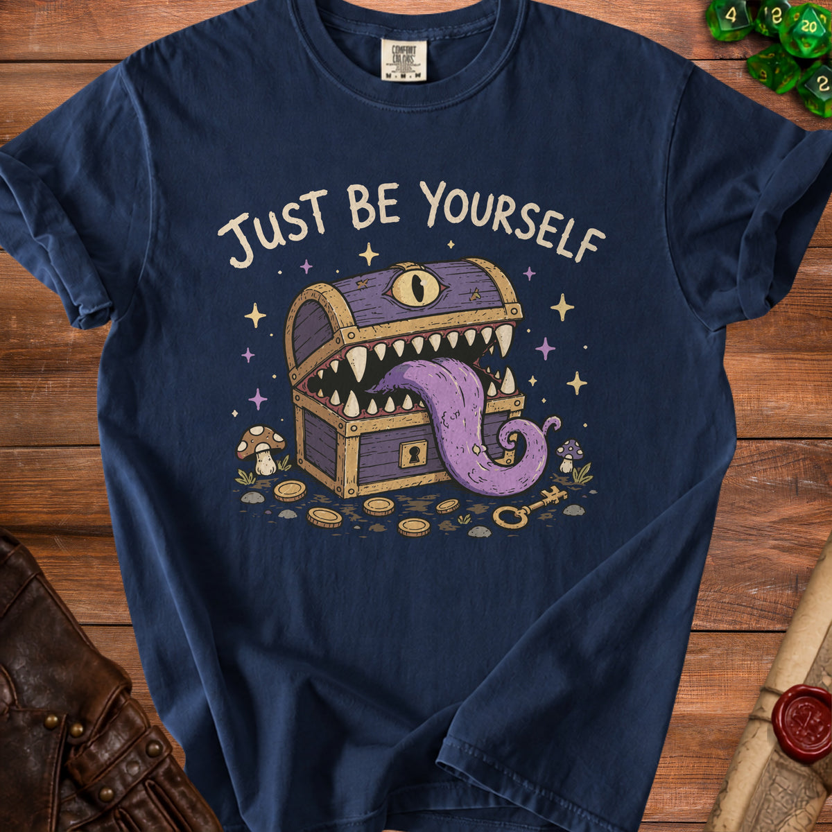 Navy t-shirt with "Just Be Yourself" text and a monster treasure chest graphic.