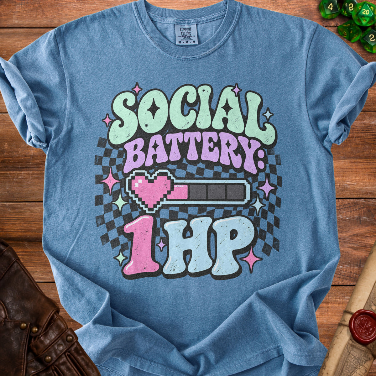 Blue t-shirt with "Social Battery 1 HP" graphic and checkerboard pattern.
