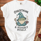 White t-shirt with graphic: "Overthink & Distract Myself" and a wizard.