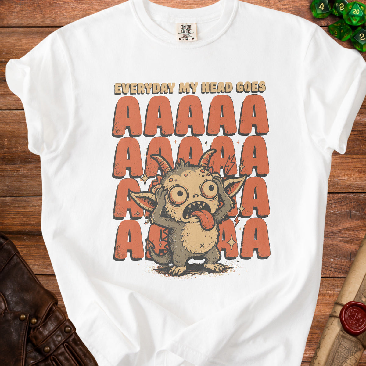 White t-shirt with "Everyday my head goes AAAAA" text and a distressed monster.
