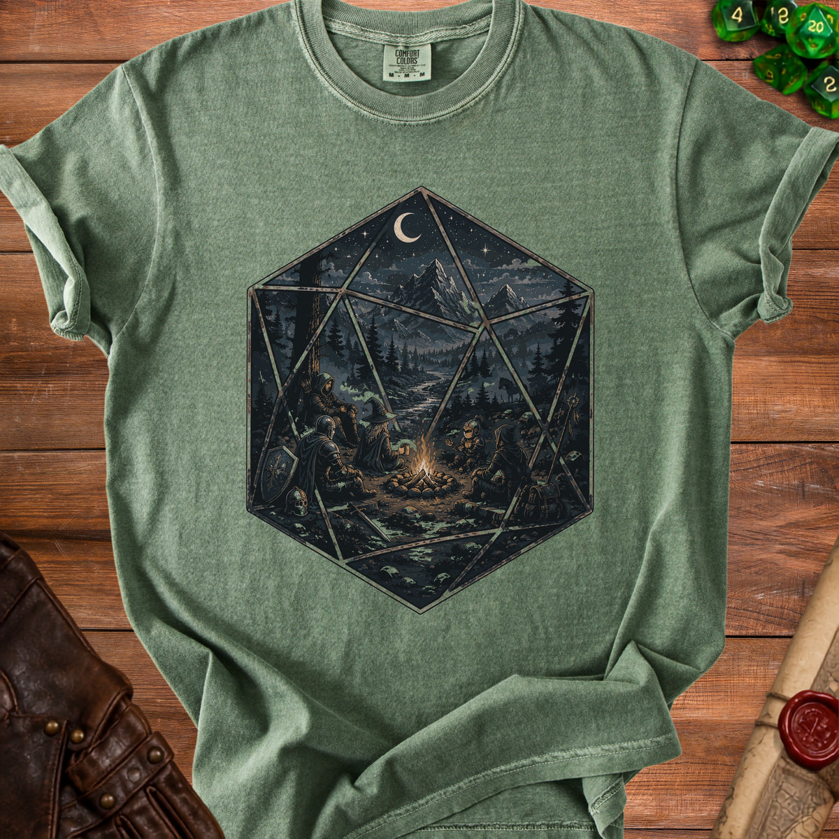 Green t-shirt featuring a D20 die with a fantasy scene inside, showing adventurers around a campfire.