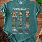 Teal t-shirt with "Dungeons & Cats" title and twelve illustrated cats dressed as fantasy characters.