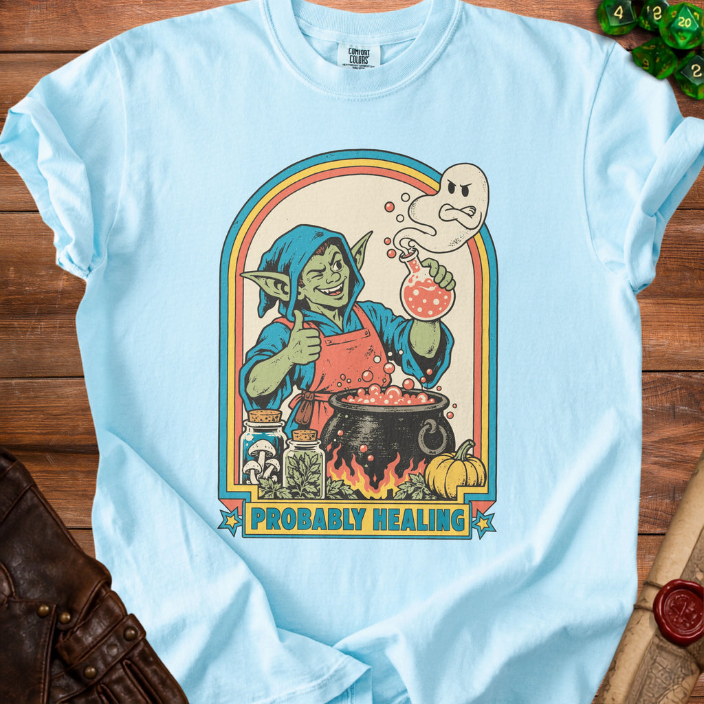 Light blue t-shirt with a goblin brewing potion under a rainbow arch.