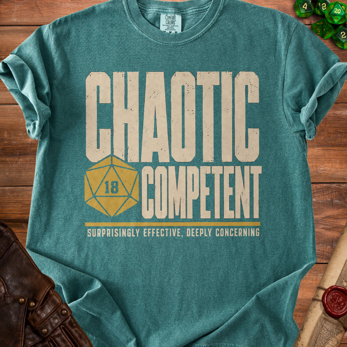 Teal t-shirt with "CHAOTIC COMPETENT" and a d20 dice.