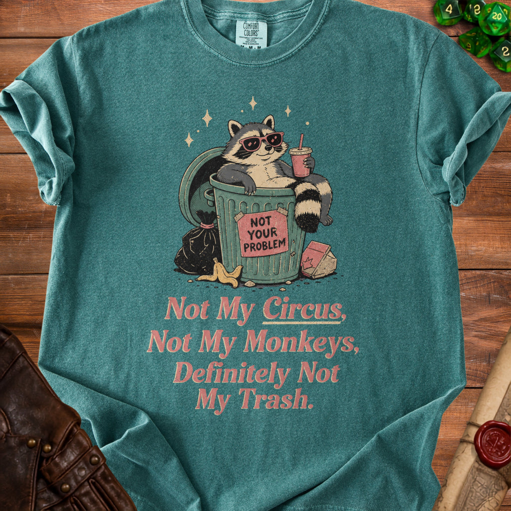 T-shirt with raccoon in trash can, "Not Your Problem" sign, and text "Not My Circus, Not My Monkeys, Definitely Not My Trash."