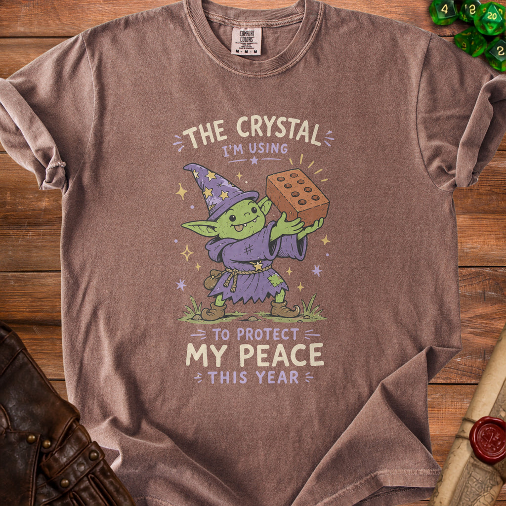 Goblin in wizard hat holds brick with text: "The crystal I'm using to protect my peace this year".