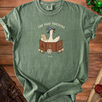 Green t-shirt with a goose in a wizard hat reading a scroll, text "The Plot Thickens".