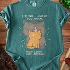 Teal t-shirt with two cats and text "I THINK I HEALED TOO MUCH. NOW I DON'T LIKE ANYONE."