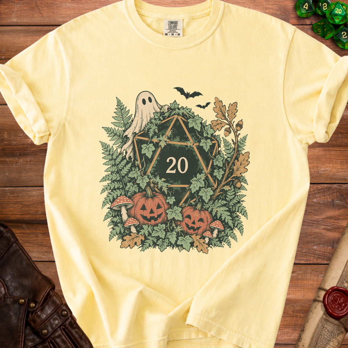 Yellow t-shirt with a D20 die, ghost, pumpkins, mushrooms, and foliage design.