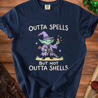 Navy t-shirt with a cartoon witch holding a shotgun and text reading "OUTTA SPELLS BUT NOT OUTTA SHELLS".