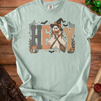 Light blue t-shirt with "HEY" and a ghost wearing a witch hat and holding brooms.
