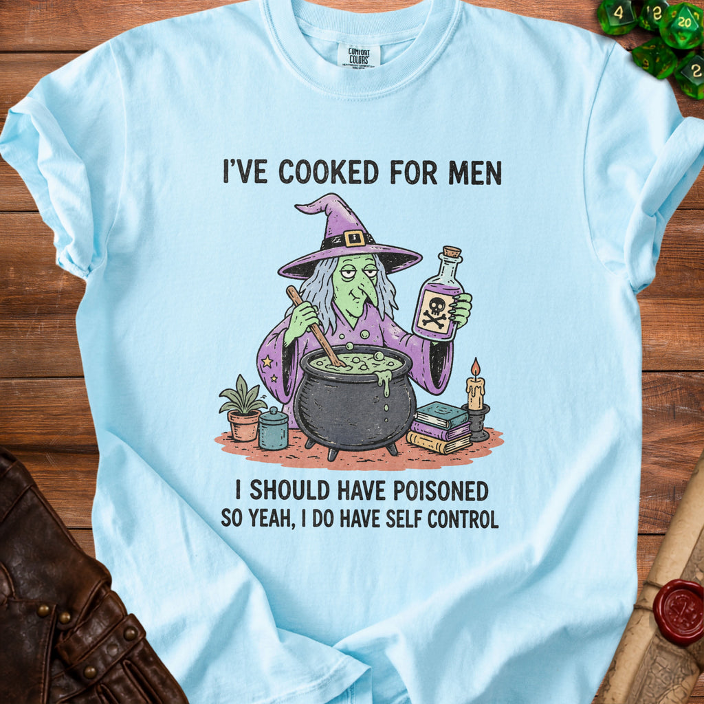 Light blue t-shirt with witch graphic and text "I've cooked for men. I should have poisoned. So yeah, I do have self control."