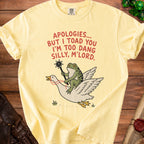 Yellow t-shirt with cartoon frog riding a goose, text "APOLOGIES... BUT I TOAD YOU I'M TOO DANG SILLY, M'LORD."