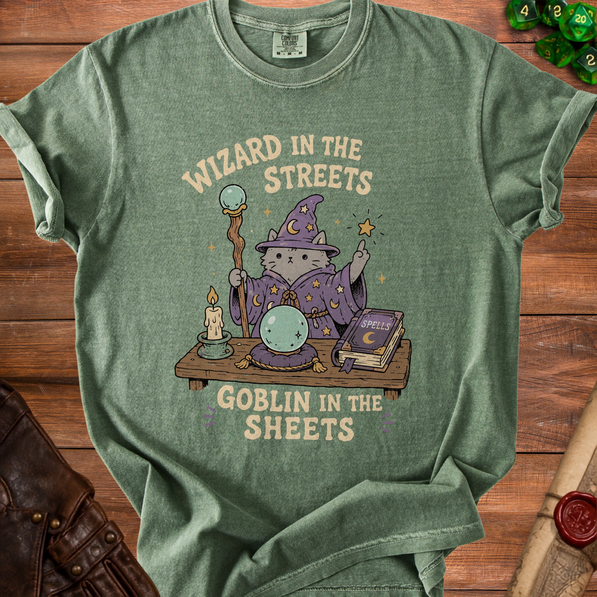 Green t-shirt with a cat wizard graphic saying "Wizard in the Streets Goblin in the Sheets".