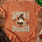 Orange t-shirt with "Spooky Spellcaster" graphic featuring a ghost and spellbook.