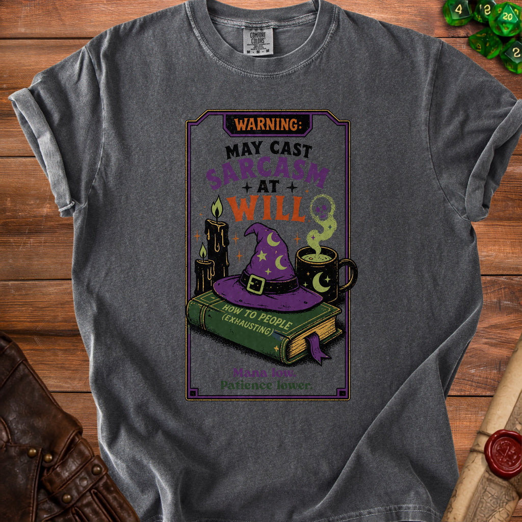 T-shirt graphic with text "Warning: May Cast Sarcasm At Will" and wizard elements.
