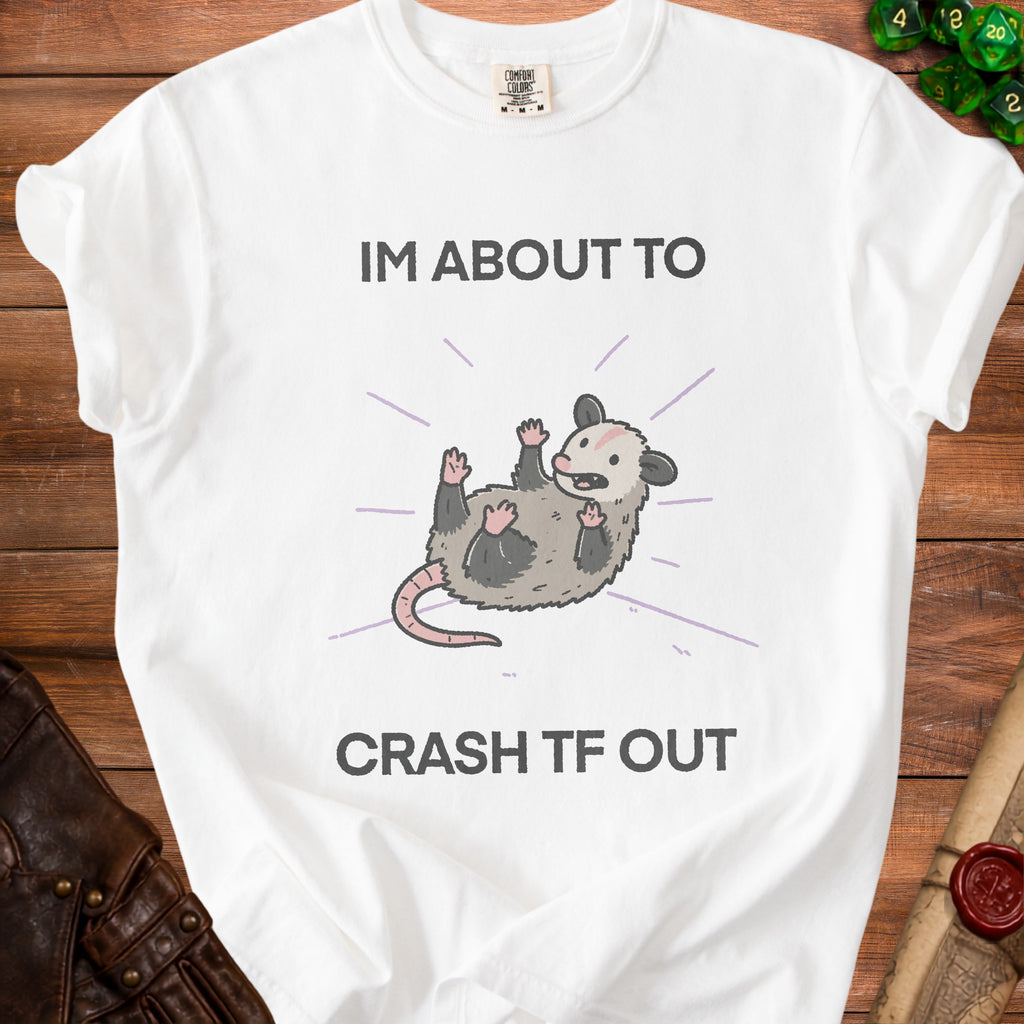 White t-shirt with text "IM ABOUT TO CRASH TF OUT" and a cartoon possum.