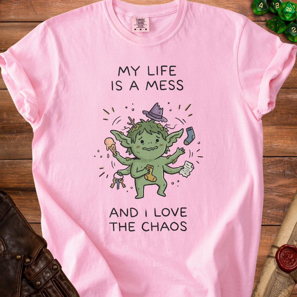 Pink t-shirt with a green, multi-armed creature, keys, sock, and ice cream. Text says "MY LIFE IS A MESS AND I LOVE THE CHAOS".