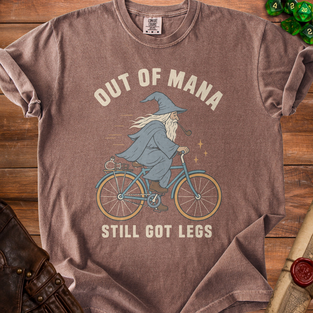 Brown t-shirt with graphic of wizard riding bicycle, text "OUT OF MANA STILL GOT LEGS".