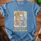 Blue t-shirt with a knight cat graphic and text "Dressed For Battle Here For Bread".