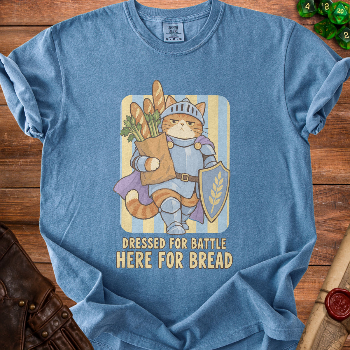 Blue t-shirt with a knight cat graphic and text "Dressed For Battle Here For Bread".
