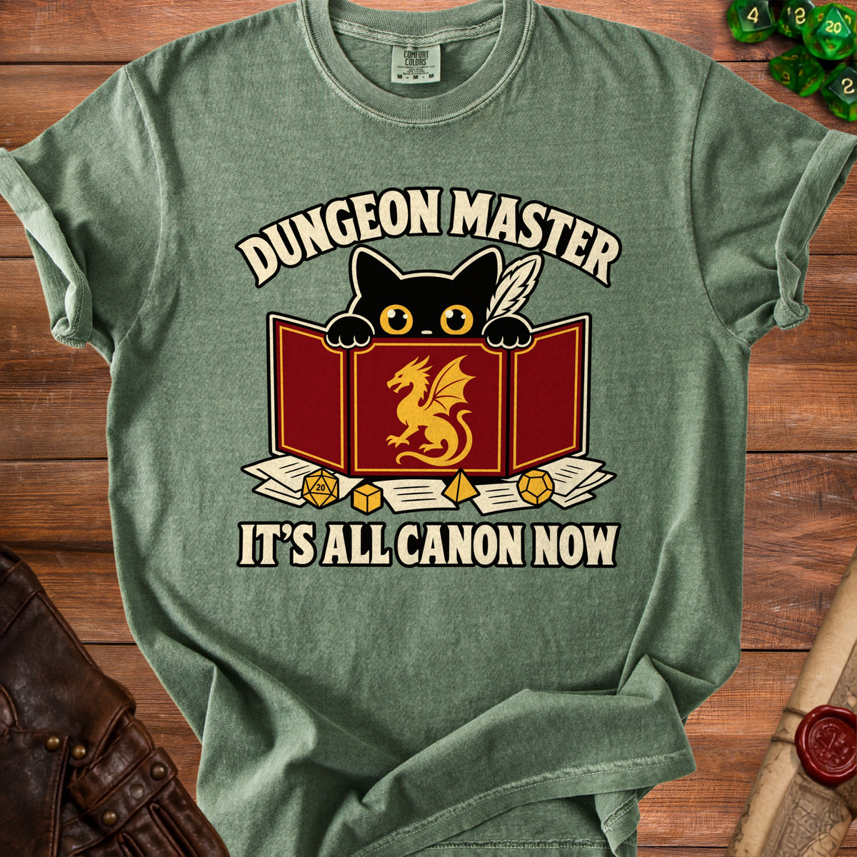Green t-shirt with black cat and dragon, reads "Dungeon Master It's All Canon Now".