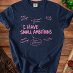 Navy t-shirt with pink text "I HAVE SMALL AMBITIONS" and related phrases.